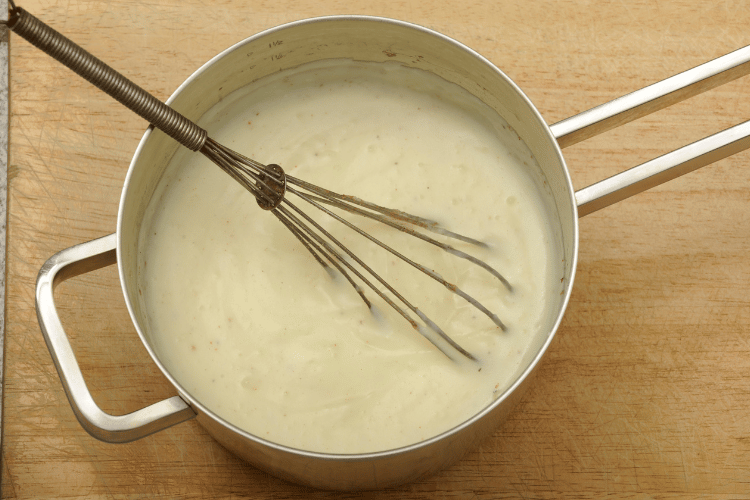 Top view of béchamel sauce in a pan