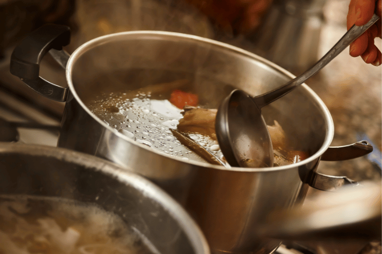 Someone preparing vegetable stock