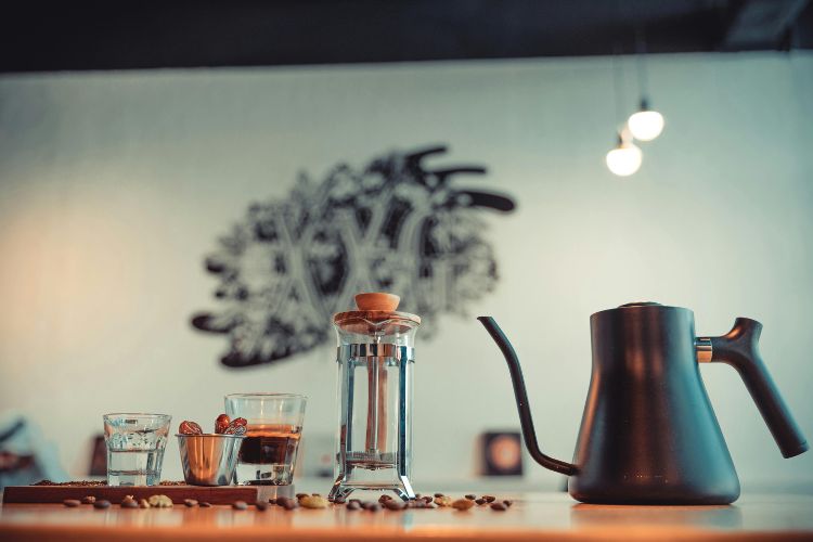 Close-up of a Kettle beside a Coffee Press