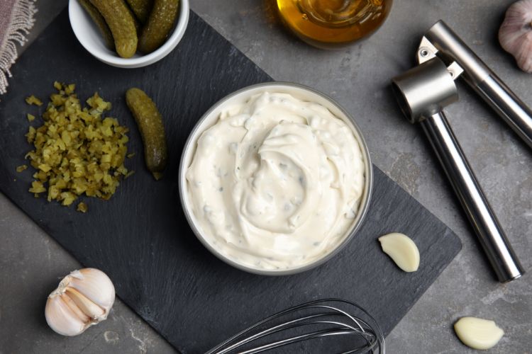 Tasty Tartar Sauce and Ingredients on grey table, flat lay