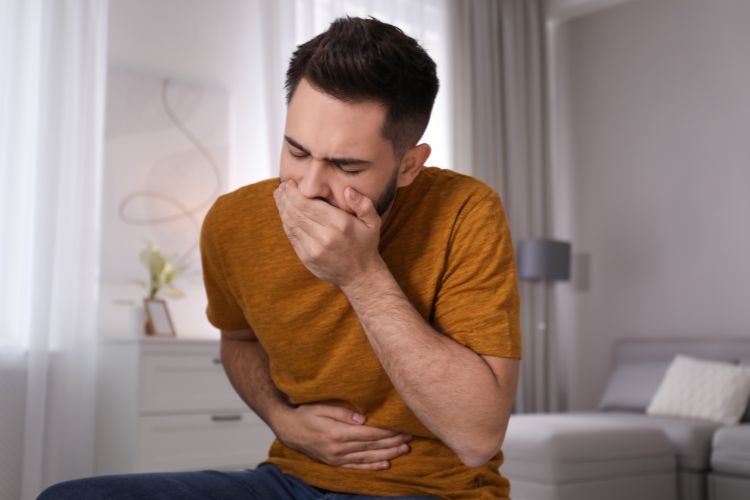 Young Man Suffering from Nausea and food poisoning at home